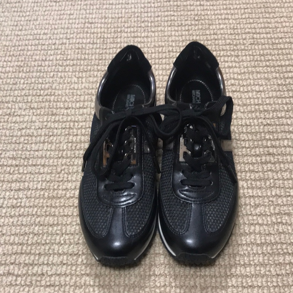 New Michael Kors sneakers. Size 7M. Black with shiny silver trim.